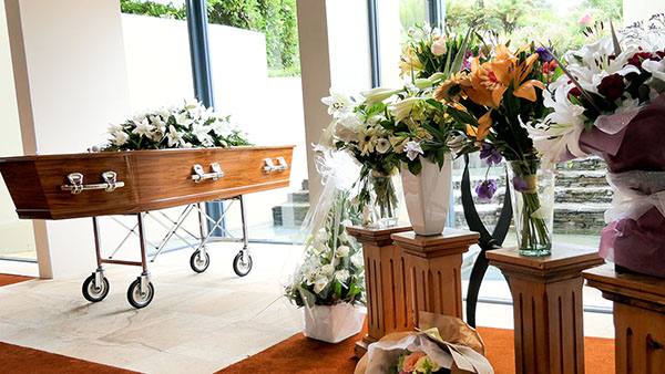 Funeral service with coffin and flowers
